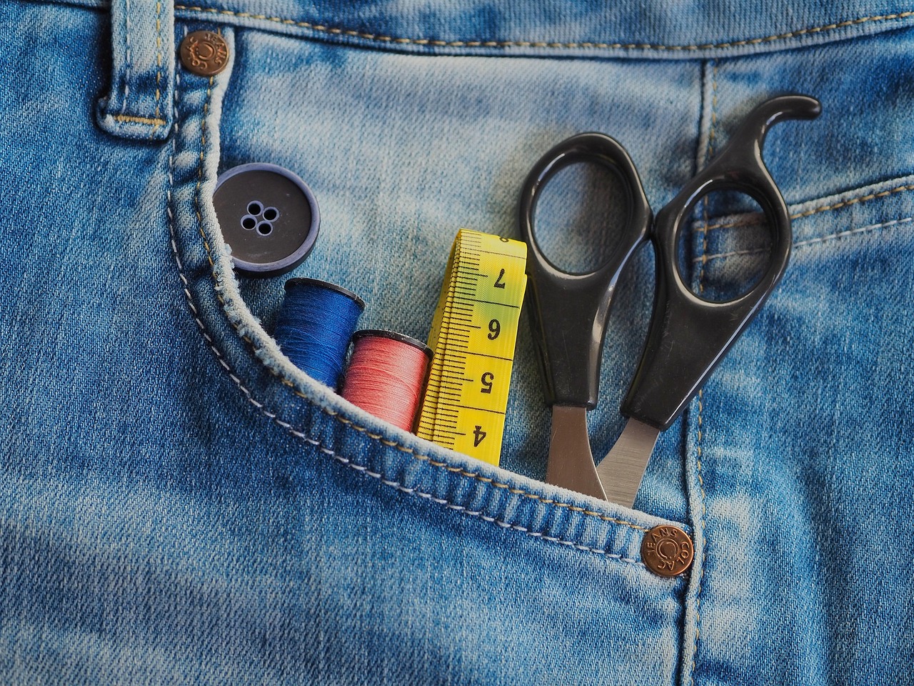 A technician taking measurements across a run of base cabinets